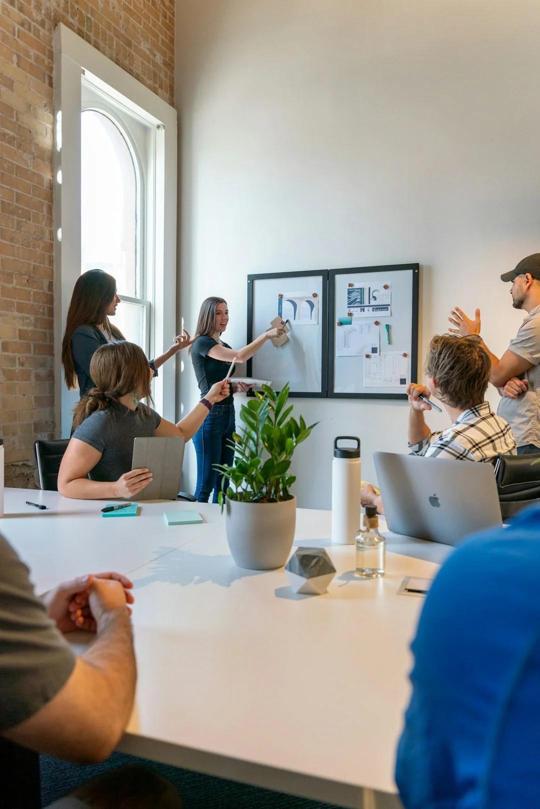 Overhead view of a business team reviewing charts and data on paper for strategic planning.
